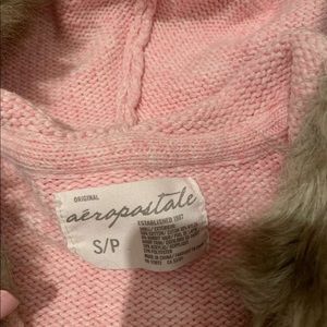 A white and pink women’s small sweater with hood